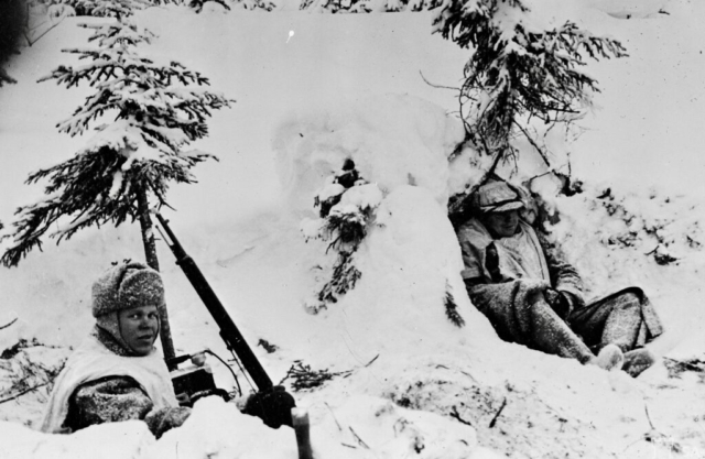 Finnish field telephone team during a battle at the front lines near Kollaanjoki, ca. January 1940. The soldier on the right is wearing what looks to be captured Russian felt boots. Photo credit SA-Kuva