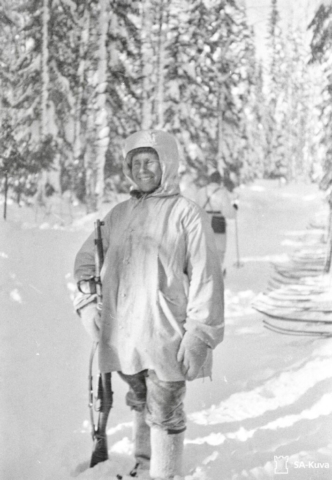 Simo Häyhä, aka the White Death, with his kit and rifle, the Finnish Mosin-Nagant, which had no scope. Note Hayha’s snow suit, which included a face mask. Photo credit SA-Kuva