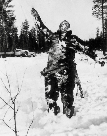 Finnish black ops: frozen Russian used as a signpost or marker. Finnish soldiers frequently propped up Russian bodies to intimidate the Soviet troops.  Photo credit SA-Kuva